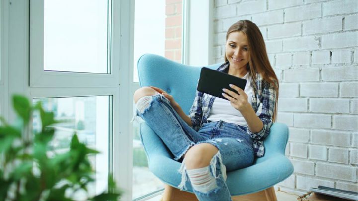 Woman reading a tablet receiving online care